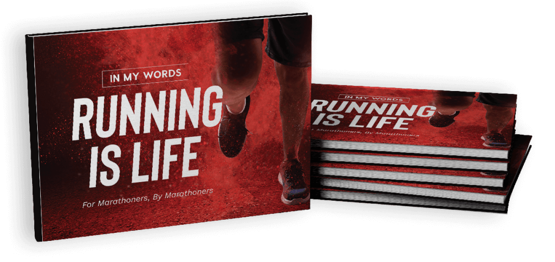 Cover of a red Running Is Life book next to a stack of them.
